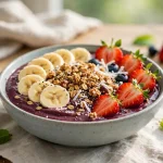 Acai bowl topped with banana, strawberries and granola