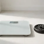 Digital bathroom scale next to a one-pound weight plate