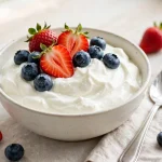 bowl of Greek yogurt with strawberries and blueberries
